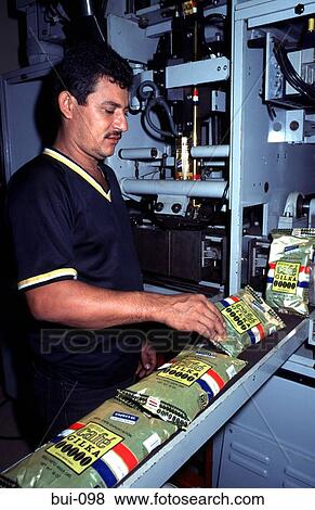 Stock Photo - Worker at Coffee Packing Production Line. Fotosearch