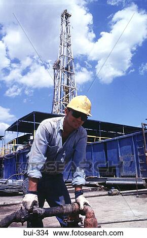 Workman and Pipework at Oil Well Colombia View Large Photo Image Picture - Workman and Pipework at Oil Well Colombia. Fotosearch