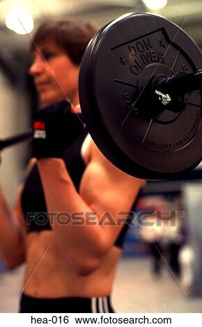 Close Up of Weights Being Lifted by Woman in Gym View Large Photo Image Stock Photograph - Close Up of Weights Being Lifted by Woman in Gym. Fotosearch