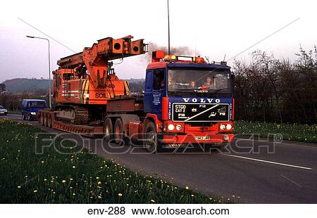 Large Flat Bed Truck Carrying Crane on UK Road View Large Photo Image Stock Photo - Large Flat Bed Truck Carrying Crane on UK Road. Fotosearch