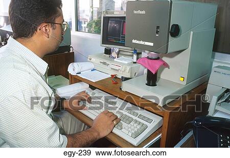 Stock Photo - Man at Colour Analysis Machine Egypt. Fotosearch