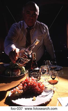 Man Pouring Brandy into a Glass View Large Photo Image Stock Photo - Man Pouring Brandy into a Glass. Fotosearch