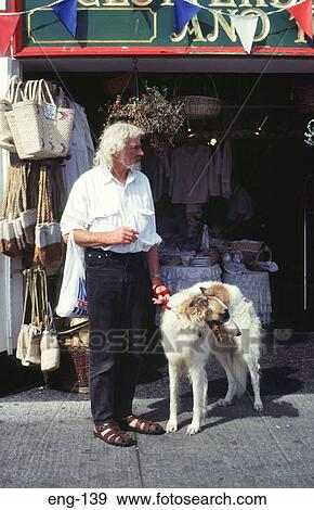 Man with Afghan Hound outside shop Cornwall England View Large Photo Image Stock Photo - Man with Afghan Hound outside shop Cornwall England. Fotosearch