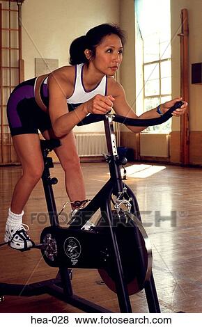 Oblique View of Woman on Exercise Bicycle View Large Photo Image Stock Photo - Oblique View of Woman on Exercise Bicycle. Fotosearch