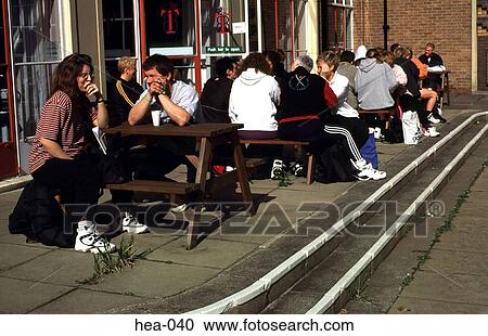 Stock Image - People Dressed in Tracksuits Outside Cafe. Fotosearch