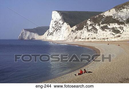 People Sitting under Chalk Cliffs Dorset England View Large Photo Image Picture - People Sitting under Chalk Cliffs Dorset England. Fotosearch