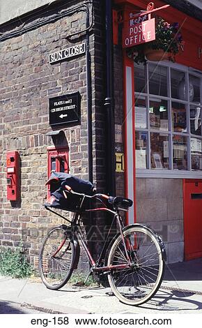 Stock Photo - Postman's Bike Against Post Office Eton England. Fotosearch