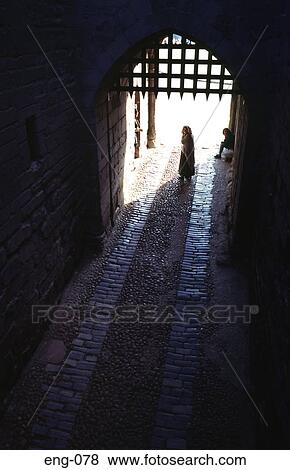 Stock Photo - Silhouette of Figure and Castle Portcullis UK. Fotosearch