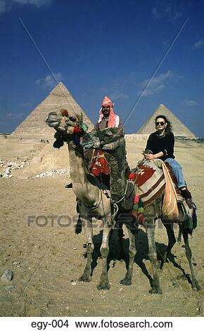 Picture - Two Camel Riders in front of Pyramids Egypt Africa. Fotosearch