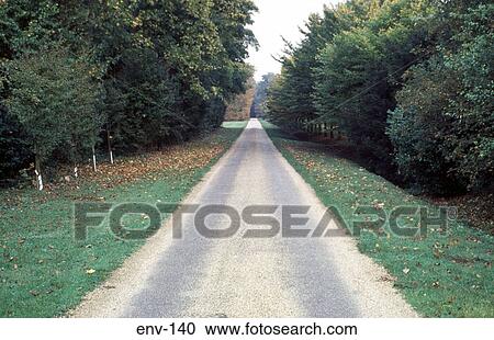 Stock Image - View down Long Straight Rural Road UK. Fotosearch
