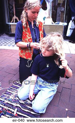 Woman Plaiting Hair of Girl on Pavement View Large Photo Image Stock Image - Woman Plaiting Hair of Girl on Pavement. Fotosearch