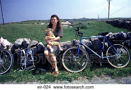 Woman with Child on Stone Wall with Bicycles View Large Photo Image Picture - Woman with Child on Stone Wall with Bicycles. Fotosearch