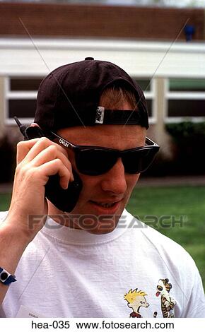 Young Man in Sporty Clothing using Mobile Phone View Large Photo Image Stock Photography - Young Man in Sporty Clothing using Mobile Phone. Fotosearch