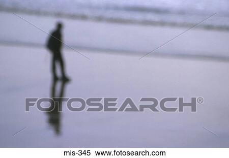 Stock Photography - Blurred View of Man on Beach UK. Fotosearch