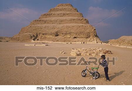 Stock Image - Boy With Bicycle by Step Pyramid Egypt. Fotosearch