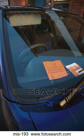 Stock Image - Car with Disabled Parking Permit in Windscreen. Fotosearch