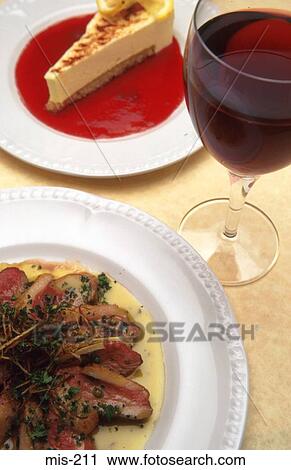 Stock Image - Close Up of Two Course Meal and Red Wine. Fotosearch