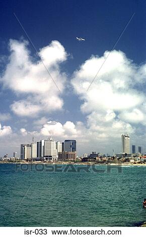 Stock Image - Clouds and Aeroplane above Tel Aviv Beach Israel. Fotosearch