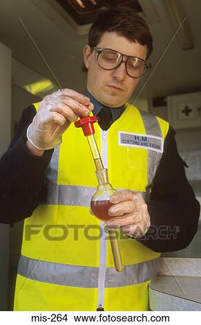 Customs Officer Testing Diesel UK View Large Photo Image Picture - Customs Officer Testing Diesel UK. Fotosearch