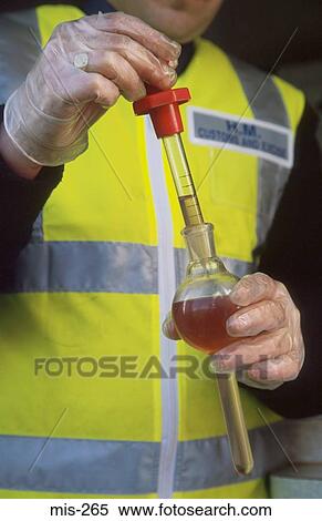 Stock Photography - Customs Officer Testing Diesel UK. Fotosearch
