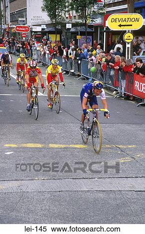 Cyclists Racing Through Town Centre View Large Photo Image Stock Photography - Cyclists Racing Through Town Centre. Fotosearch