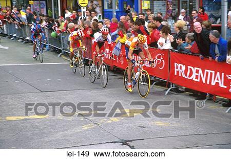 Cyclists Racing Through Town View Large Photo Image Stock Photo - Cyclists Racing Through Town. Fotosearch