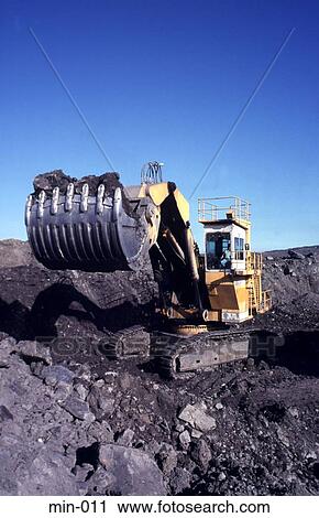 Stock Image - Digger Scooping Up Coal Trimsaran Mine Wales. Fotosearch