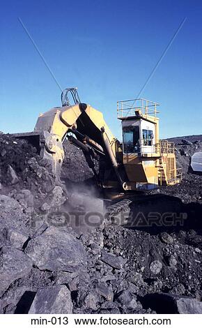 Stock Image - Digger Scooping Up Coal Trimsaran Mine Wales. Fotosearch