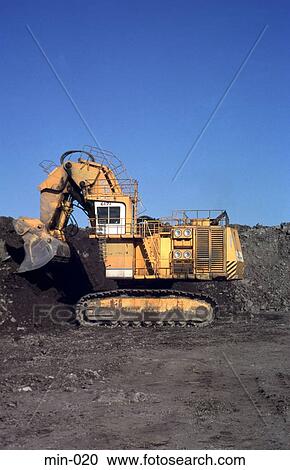 Stock Image - Digger Scooping Up Coal Trimsaran Mine Wales. Fotosearch