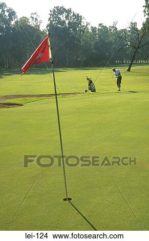 Picture - Golfer Trying to hit Green. Fotosearch