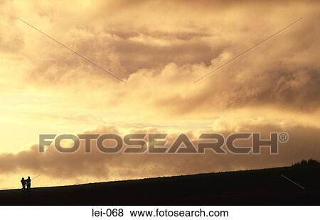 Lone Walker on Hillside with Sunset View Large Photo Image Stock Photo - Lone Walker on Hillside with Sunset. Fotosearch