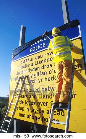 Man Changing Motorway Sign Wales UK View Large Photo Image Stock Photo - Man Changing Motorway Sign Wales UK. Fotosearch