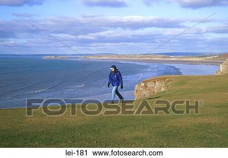 Man Hiking along Cliff Edge Gower Wales View Large Photo Image Stock Image - Man Hiking along Cliff Edge Gower Wales. Fotosearch