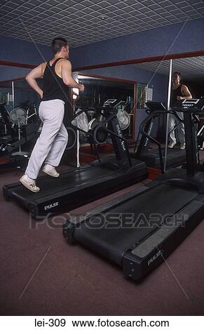 Man on Running Machine UK View Large Photo Image Stock Photo - Man on Running Machine UK. Fotosearch