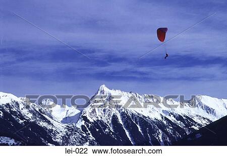 Man Para-gliding over the Alps View Large Photo Image Stock Image - Man Para-gliding over the Alps. Fotosearch
