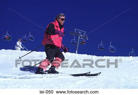 Man Skiing with Chairlift in Background View Large Photo Image Stock Image - Man Skiing with Chairlift in Background. Fotosearch
