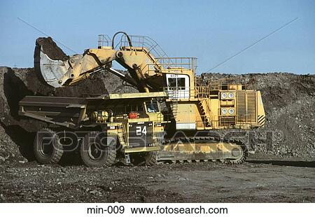 Stock Photo - Mechanical Digger Loading Truck Trimsaran Mine Wales. Fotosearch
