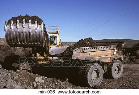 Stock Photograph - Mechanical Digger Loading Truck Trimsaran Mine Wales. Fotosearch