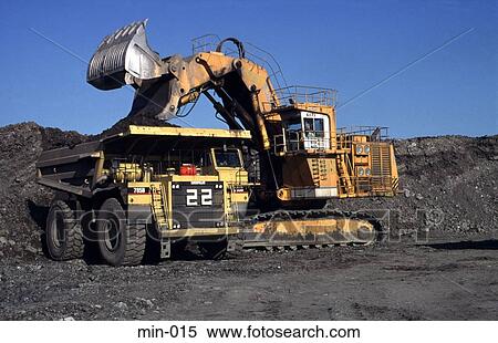 Stock Photography - Mechanical Digger Loading Truck Trimsaran Mine Wales. Fotosearch