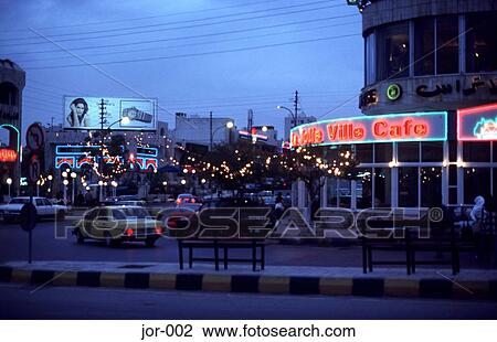 Stock Image - Neon Signs and Traffic at Night Amman Jordan. Fotosearch