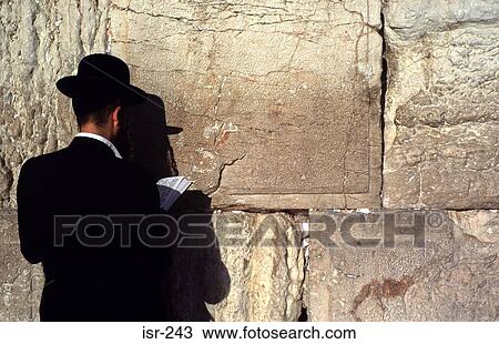 Stock Image - Orthodox Jewish Man Facing Western Wall Jerusalem. Fotosearch