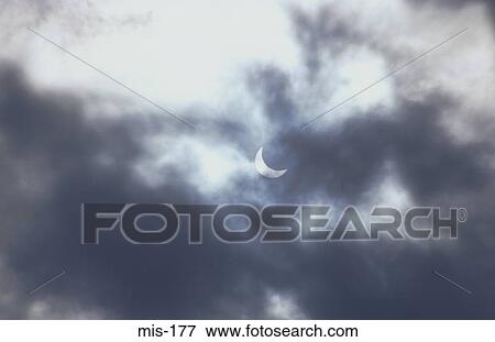Patial Eclipse through Clouds View Large Photo Image Stock Photo - Patial Eclipse through Clouds. Fotosearch