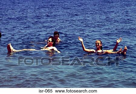 Stock Photography - People Floating in the Dead Sea Israel. Fotosearch