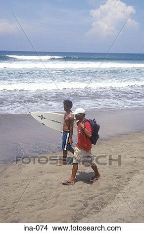 Picture - People walking on Beach with Surfboard Kuta Beach Bali. Fotosearch