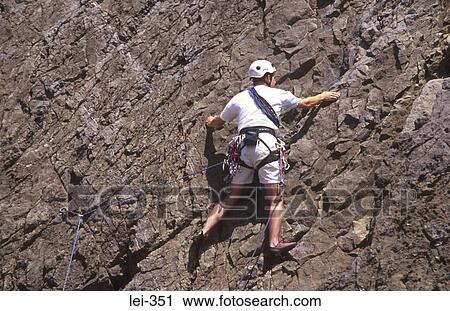 Stock Image - Rock Climber Three Cliffs Bay Wales UK. Fotosearch