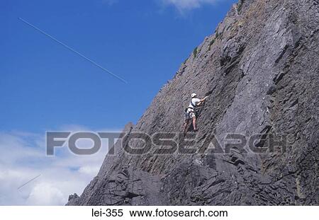 Stock Photography - Rock Climber Three Cliffs Bay Wales UK. Fotosearch