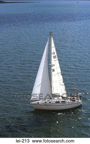 Stock Image - Small Sailing Boat at Sea Wales. Fotosearch