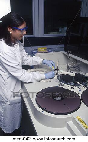 Technician Operating Automated Reagent Equipment UK View Large Photo Image Stock Image - Technician Operating Automated Reagent Equipment UK. Fotosearch