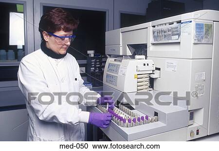 Technician Operating Automated Reagent Equipment UK View Large Photo Image Stock Image - Technician Operating Automated Reagent Equipment UK. Fotosearch
