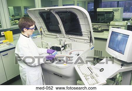 Stock Image - Technician Operating Automated Test Equipment UK. Fotosearch